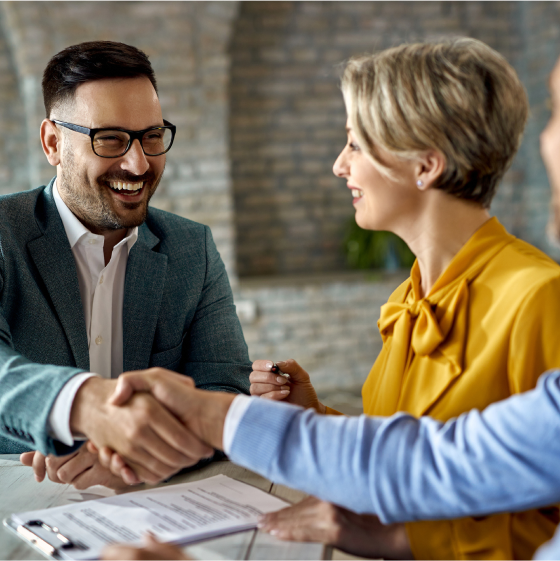 Financial professional shaking hands with clients who just purchased a variable annuity.