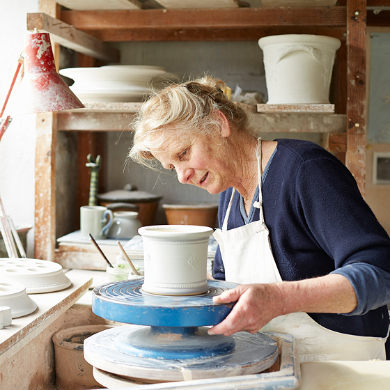 Woman, who represents a potential ProPayer Income Annuity client, works in her pottery studio.