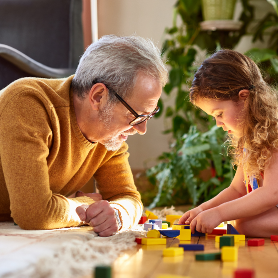 Man, who represents potential Protective Indexed Annuity II client, plays with his granddaughter.