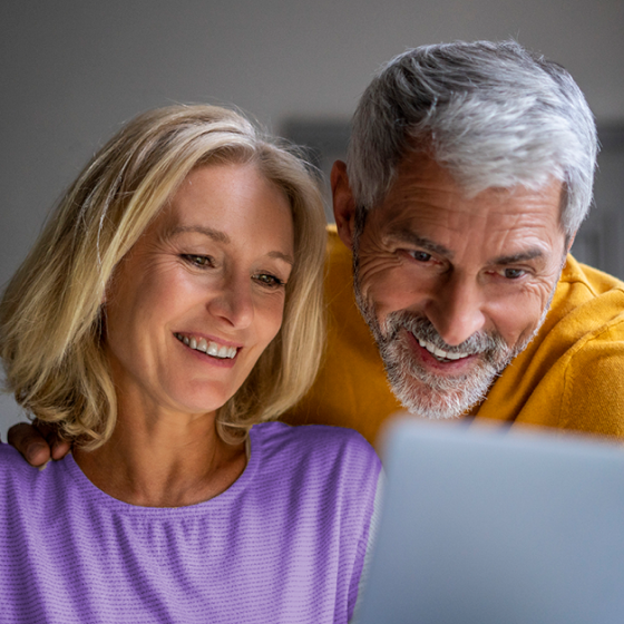 Clients review Protective Indexed Annuity II information on their laptop.
