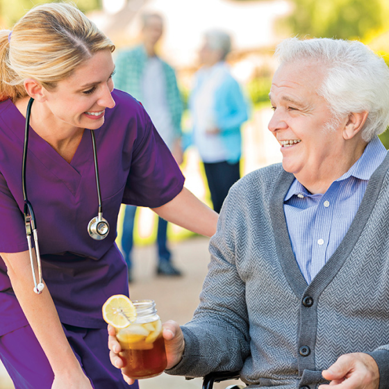 Elderly man enjoying time outside with his caregiver.