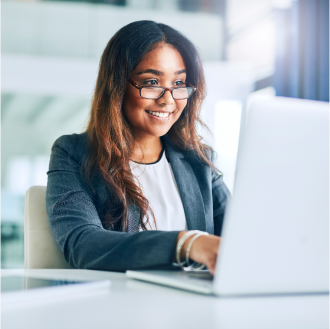 A financial professional using a laptop to check on the status of her client's claim with Protective.