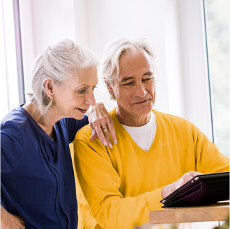 Husband and wife reviewing information about a variable annuity that fits their risk-tolerance, growth-focused retirement savings objectives.