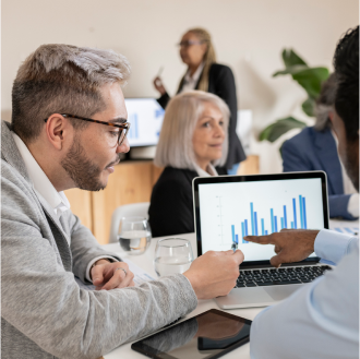 Financial professionals explore fund performance tools from Protective on a laptop.